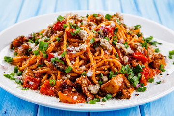 Pasta with meat and tomato sauce on wooden table
