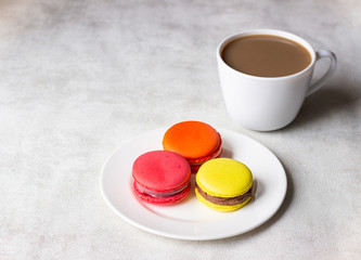 Cup of coffee with colorful french macarons. 