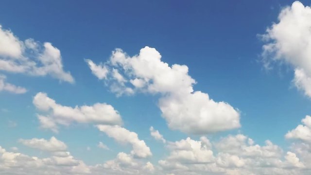 mottled clouds floating on a blue sky.