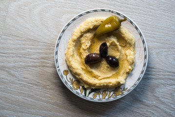 Homemade pasta hummus on a plate on a white rustic table