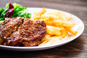 Grilled beefsteak with french fries and vegetable salad