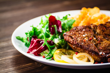 Grilled beefsteak with french fries and vegetable salad