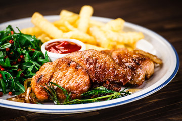 Grilled beefsteak with french fries and vegetable salad