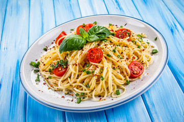 Pasta with vegetables on wooden table