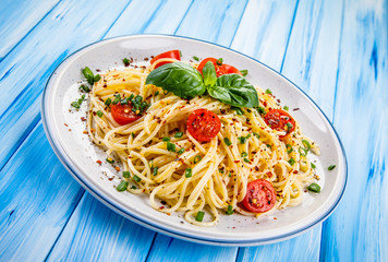 Pasta with vegetables on wooden table