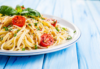 Pasta with vegetables on wooden table