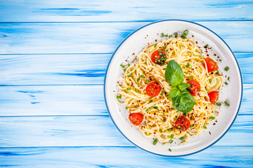 Pasta with vegetables on wooden table