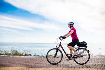 Fototapeta na wymiar Healthy lifestyle - middle-aged woman riding bicycles