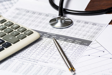 Health care costs. Stethoscope and calculator symbol for health care costs or medical insurance