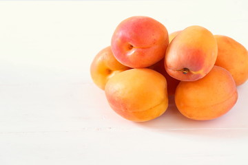 Fototapeta na wymiar Fresh apricots on white surface