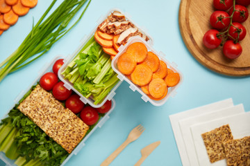 flat lay with cutlery and healthy food composition isolated on blue