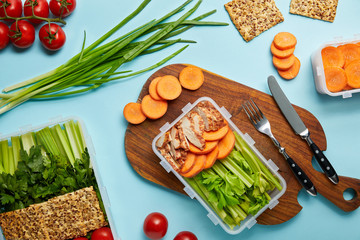 flat lay with cutlery and healthy food composition isolated on blue