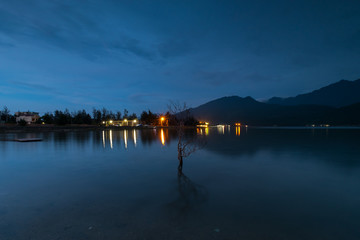 Sunset on Lap An lagoon and Lang Co Bay with colorful layers of cloud and . Lang Co Bay is one of the famous and beautiful bays of the world. HUE - VIET NAM