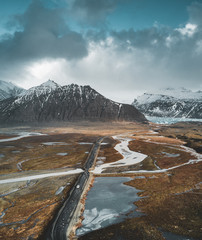 Vatnajokull glacier aerial drone image with street highway and clouds and blue sky. Dramatic winter scene of Vatnajokull National Park, Iceland, Europe. Beauty of nature concept background.