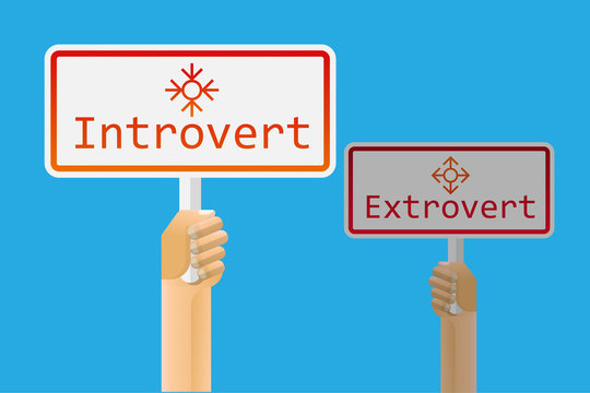 Hand Holding Introvert And Extrovert Sign.