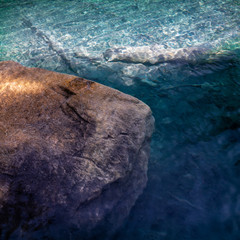 Beautiful, rugged stone in a swiss alpine lake. Beautiful, clear, fresh water.