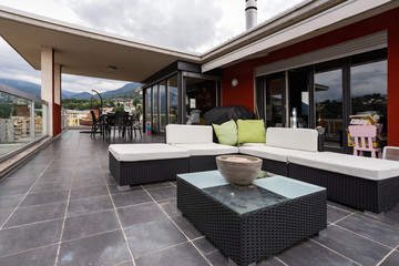 Large terrace furnished with outdoor furniture
