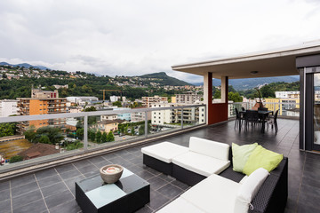 Large terrace furnished with outdoor furniture