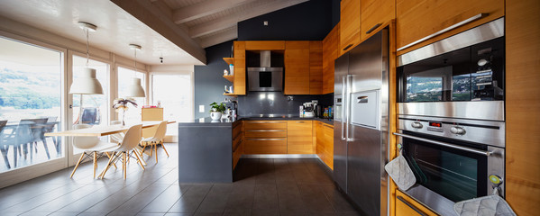 Front view modern wooden kitchen with table and chair