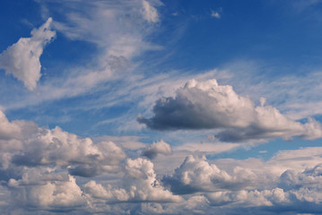 A pile of white dense clouds above each other in a low-lying blue sky. A beautiful and colorful picture.