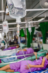Patient with saline solution drip for treatment in the hospital.