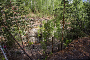 Abandoned ore mica mine quarry open pit in forest