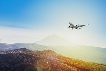 airplane flying on sunset sky background  - travel concept 