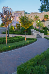 A promenade with stairs leading to a wall with an ornamental Azerbaijani carpet