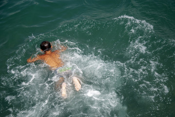Children swim in the sea