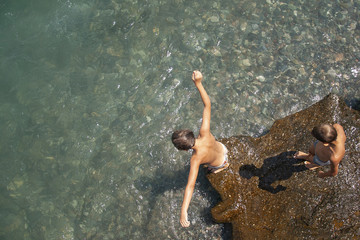 Children jump from above into the water and bathe