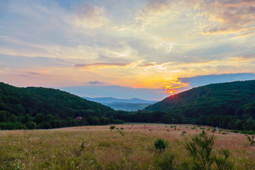 Sunset against the background of the vast mountains and colorful beautiful sky