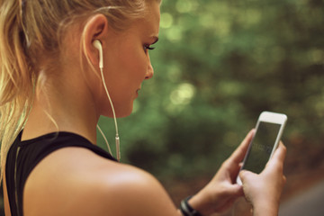 Fit young woman checking her time while out for a run