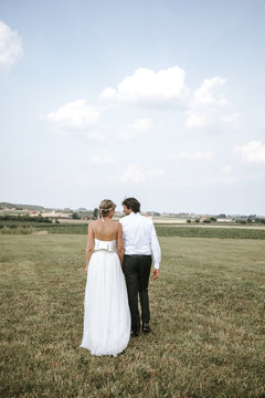 bride and groom kissing in front of landscape