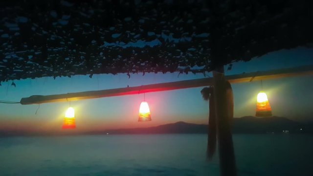 Summer sea night view at Kalamos in Greece against the lights.