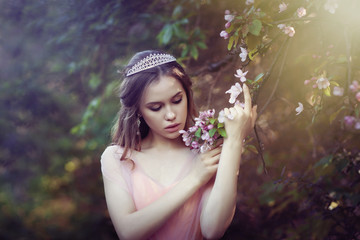 girl in a pink dress in a flower garden