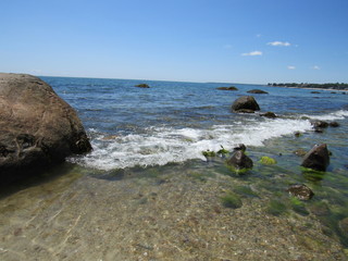A beautiful rocky beach on a sunny day with blue sky 