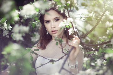 Beautiful young bride in a blooming garden
