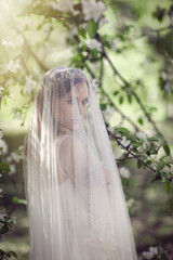 Beautiful young bride in a blooming garden