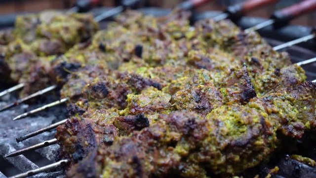 Extreme closeup of marinated beef shish kabobs on a hot grill.
