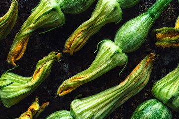Fresh pumpkin flowers with baby pumpkin just come from the garden. Rustic background