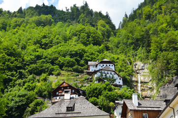 Fototapeta na wymiar Picturesque view of town with beautiful buildings near mountain forest