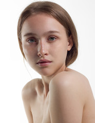 Fototapeta premium The beautiful gentle girl the blonde with ideal skin on a white background. Natural beauty, day make-up. Beauty, purity. Cosmetology and Spa procedures.