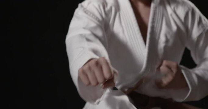 Fast Karate punches close up with sound on black