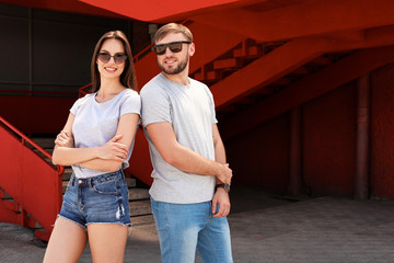 Young couple wearing gray t-shirts on street