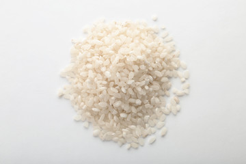 Raw rice on white background. Healthy grains and cereals