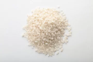 Gordijnen Raw rice on white background. Healthy grains and cereals © New Africa