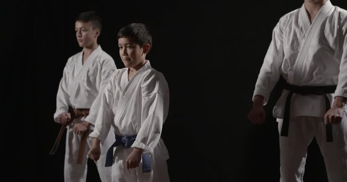 Karate kids kata beginning kata Heian Nidan on black 50fps