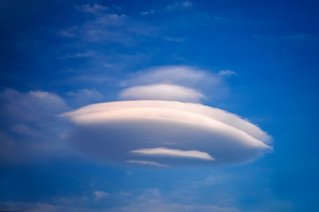Ufo-shaped cloud against blue sky on Crete Island in Greece