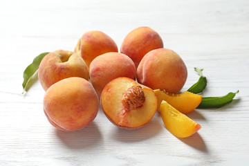 Fototapeta na wymiar Fresh sweet peaches on wooden table