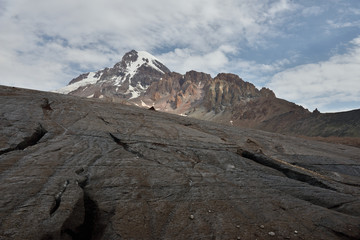 Fototapeta na wymiar Caucasus mountains, snowy peak on Kazbegi and Gergeti glacier, Stepantsminda, Georgia